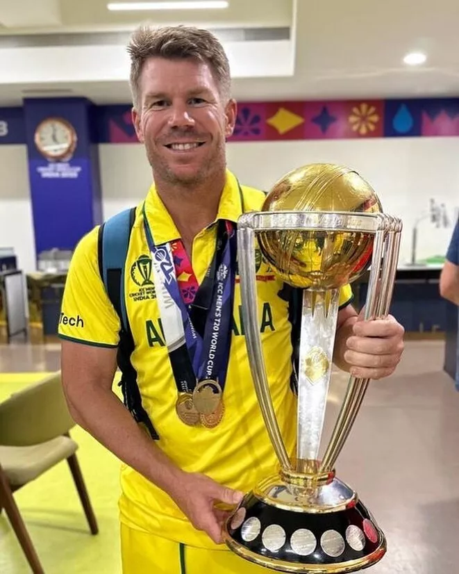 David Warner poses with the ICC Cricket World Cup trophy