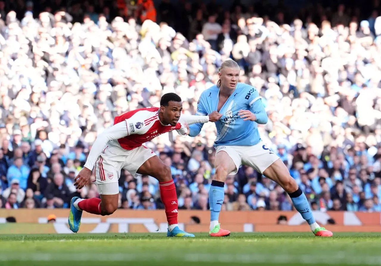 Arsenal's Gabriel Magalhaes (left) marks Manchester City's Erling Haaland Manchester City v Arsenal - Premier League - Etihad Stadium